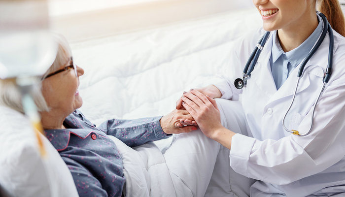 smiling-doctor-holding-patient-hand.jpg